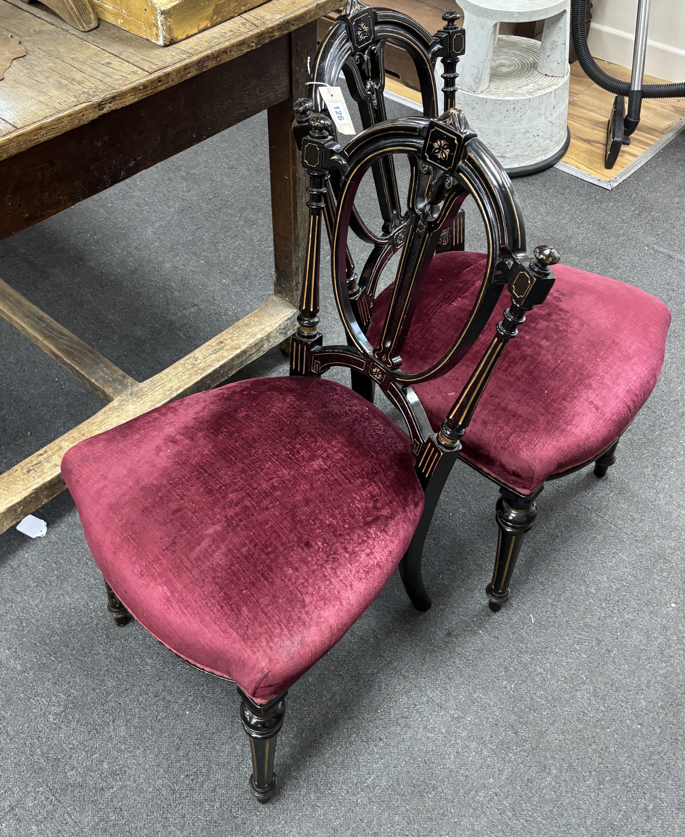 A pair of late Victorian parcel gilt salon chairs